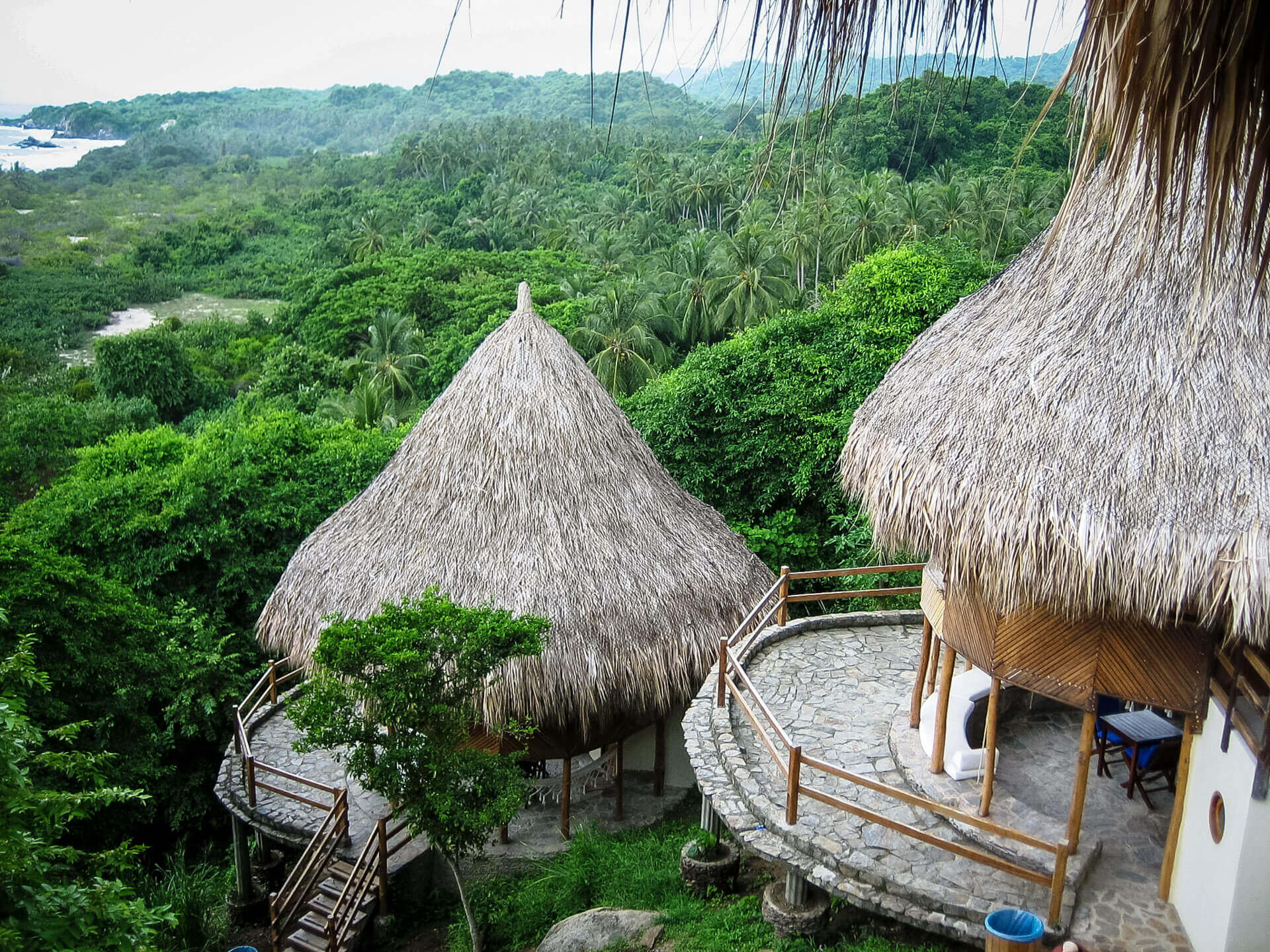 Thatched eco-huts overlooking Tayrona's tropical jungle down to the coast